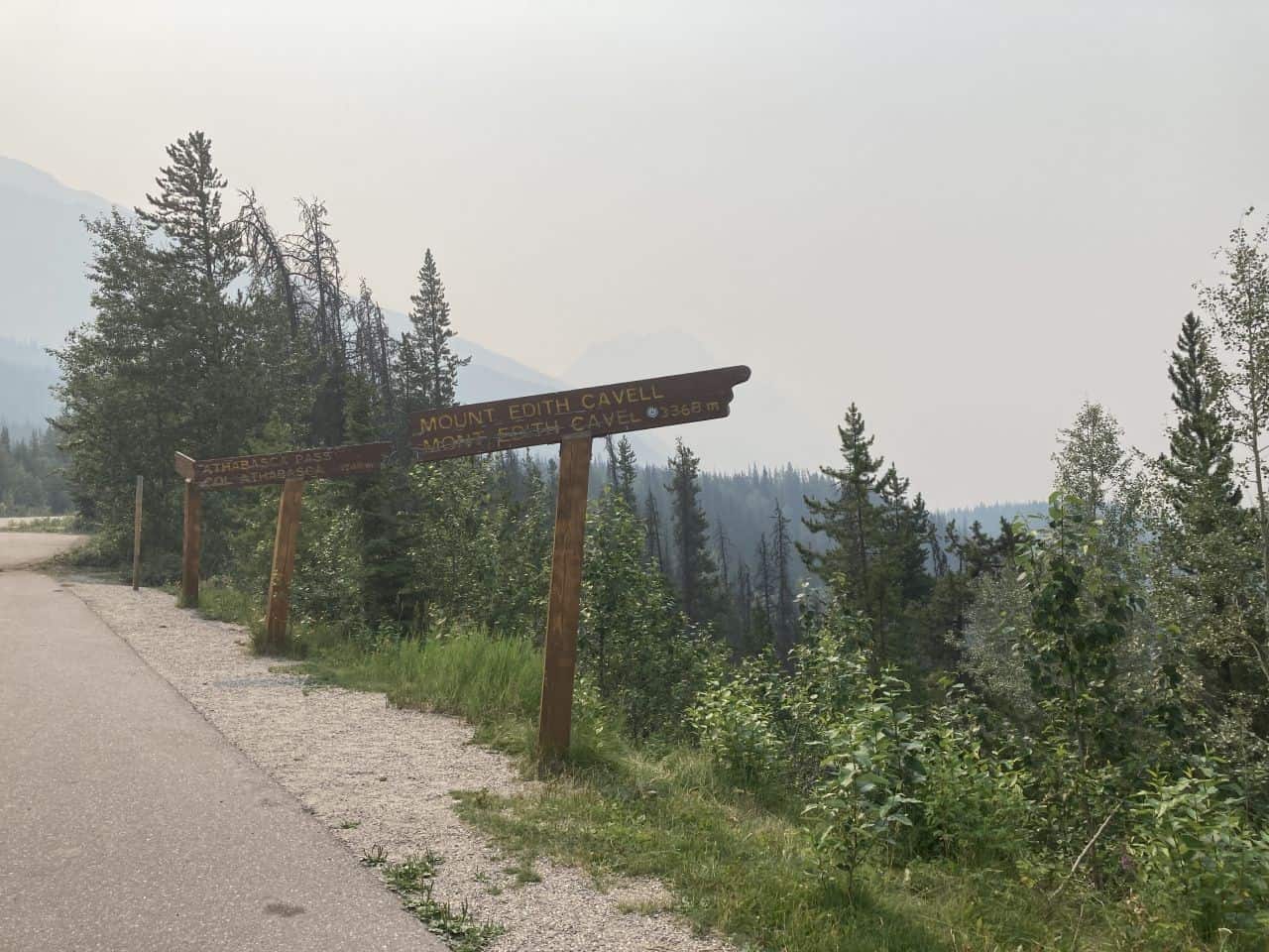 Sign makers pointing out famous sights on the Icefields Parkway in Jasper National Park. These two point to Mount Edith Cavell and Athabasca Pass and are normally a fantastic site if not obscured by smoke from forest fires.