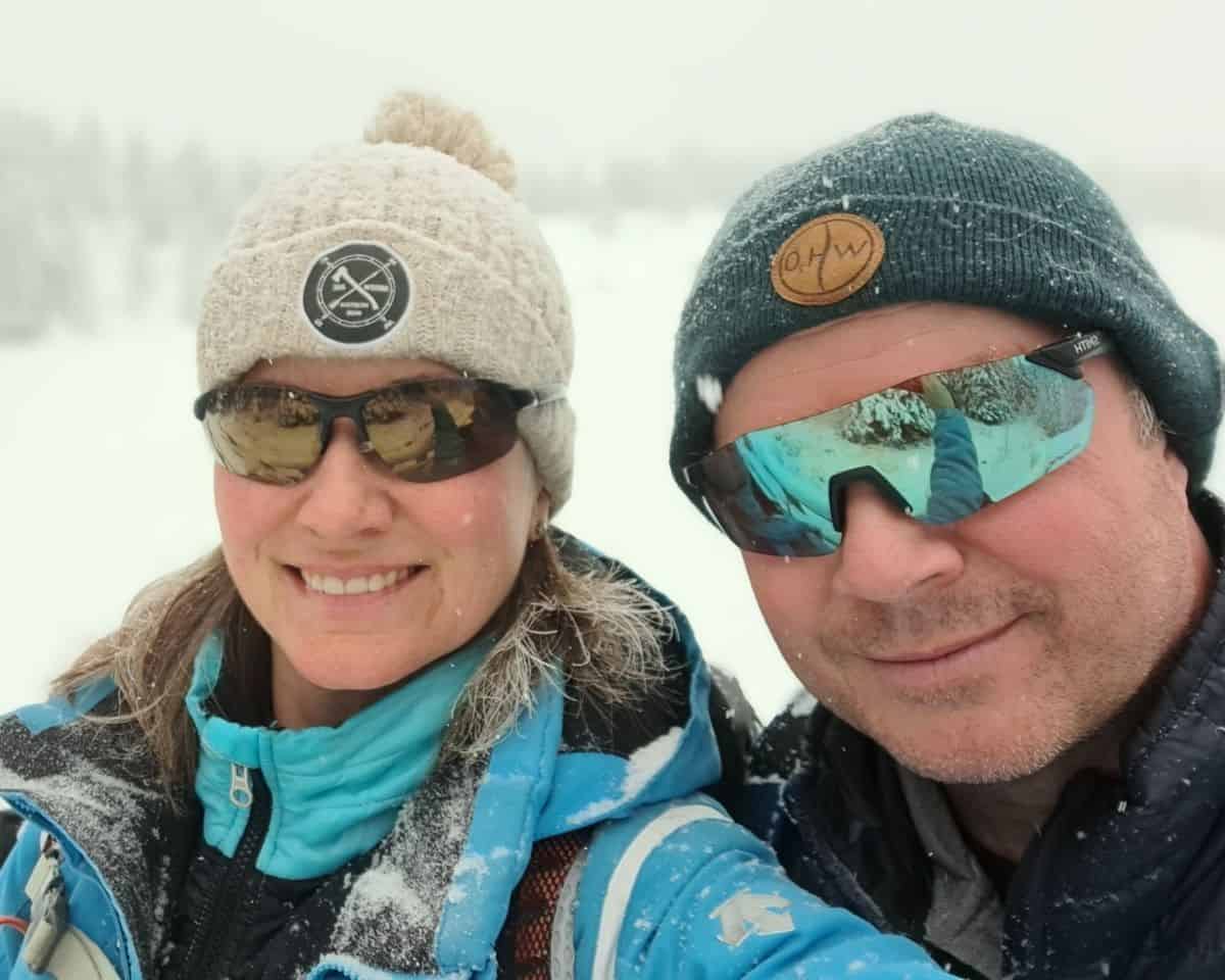 Two winter adventure seekers are enjoying the winterwith a snowshoe around Johnson Lake in Banff National Park Canada.