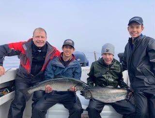 Fishing salmon with the family near BC Ferry Terminal by Bear Cove Cottages in Port Hardy.