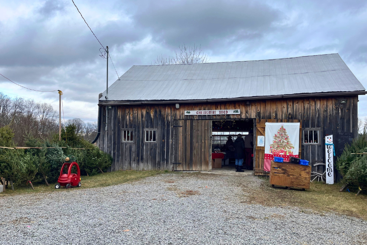 Rustic wooden barn with holiday decorations marking 