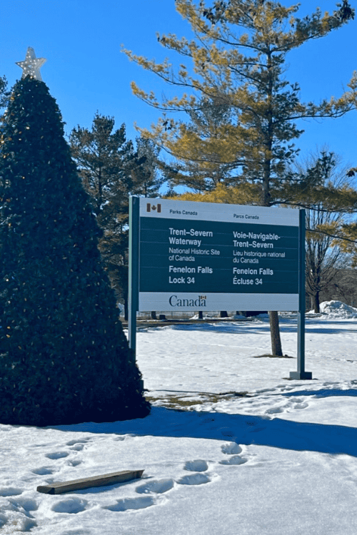 Fenelon Falls and Lock 34 Winter Adventures in Ontario Canada. Parks Canada sign indicating that this area is the Trent-Severn Waterway including Fenelon Falls and Lock 34.