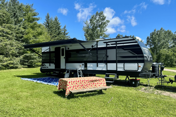 Camper trailer on a sunny campground at OWL Rafting on the Ottawa River, Ontario, Canada