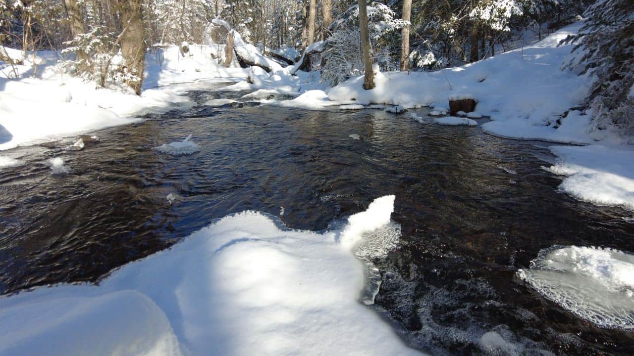 Snow capped rocks on open water at the  Ontario Winter Getaway At Silent Lake Provincial Park