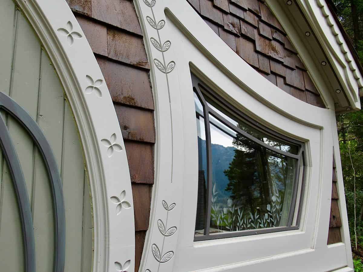 Close up of white wood trim details and etched pattern on window glass. Photo credit: Megan Kopp