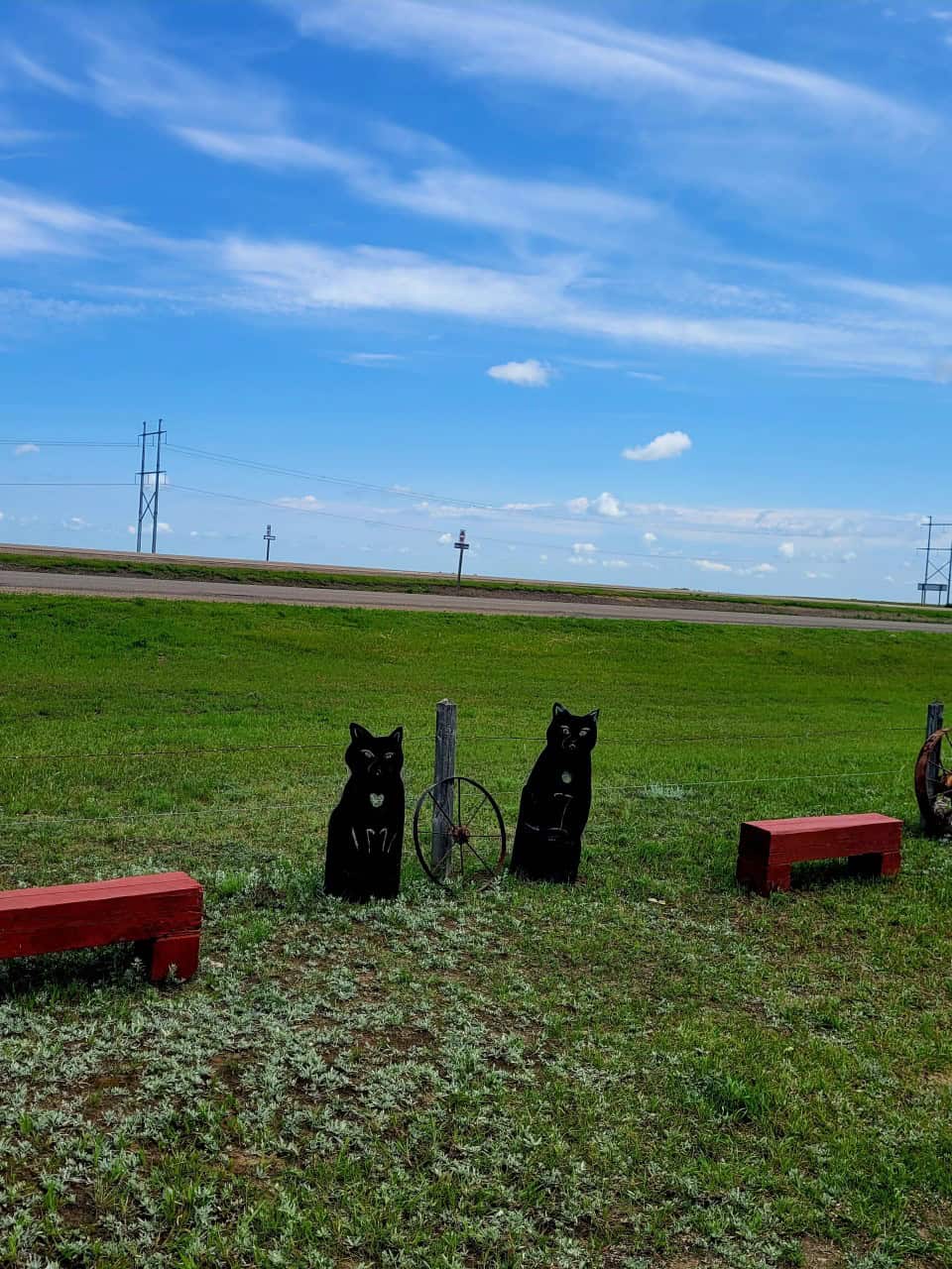 Metalwork Cats - Mortlach Saskatchewan - The Trans Canada Highway #1 can be seen behind these metalwork black cats in Mortlach, Saskatchewan, Canada.