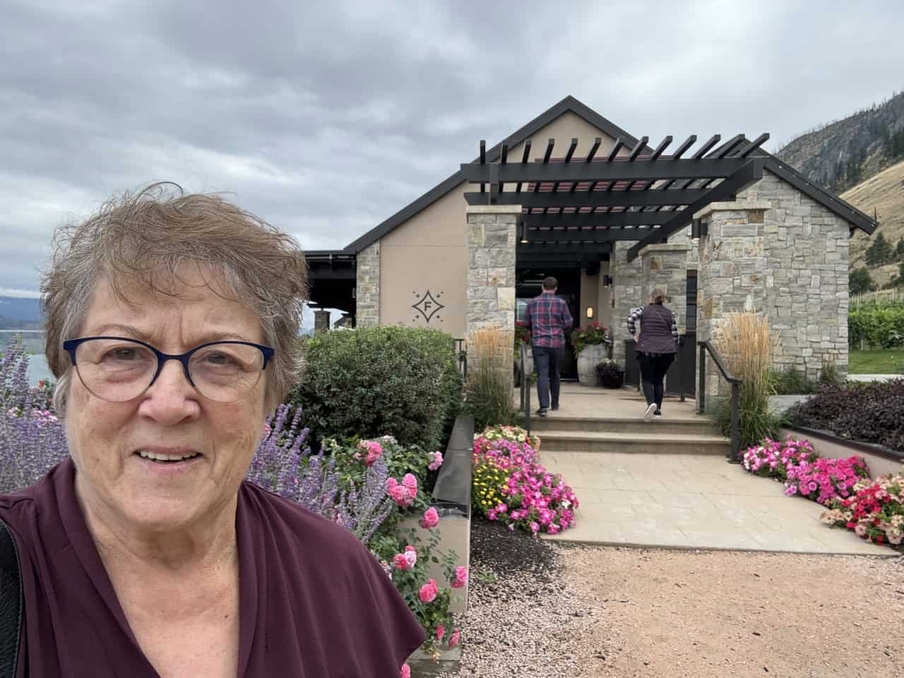 Selfie at Fitzpatrick Vineyards in Peachland BC 2024-09-28 - A selfie at the entrance to the Fitzpatrick Vineyards. Beautiful entryway lined with flowers. 