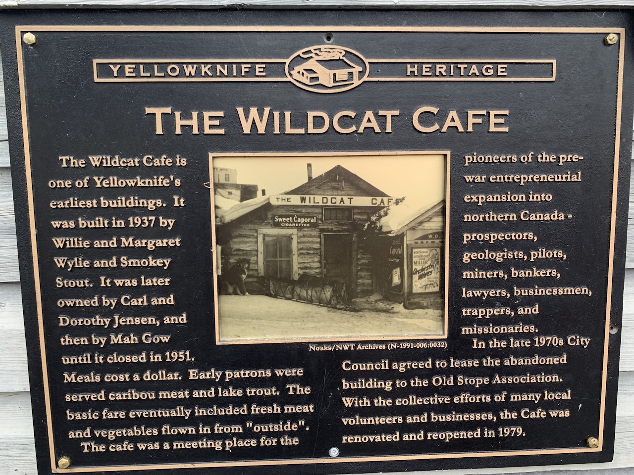 Wildcat Café Historical Plaque in Yellowknife Northwest Territories Canada - This Yellowknife Heritage plaque can be found on the side of the Wildcat Café. It provides a history of the building and surrounding areas.