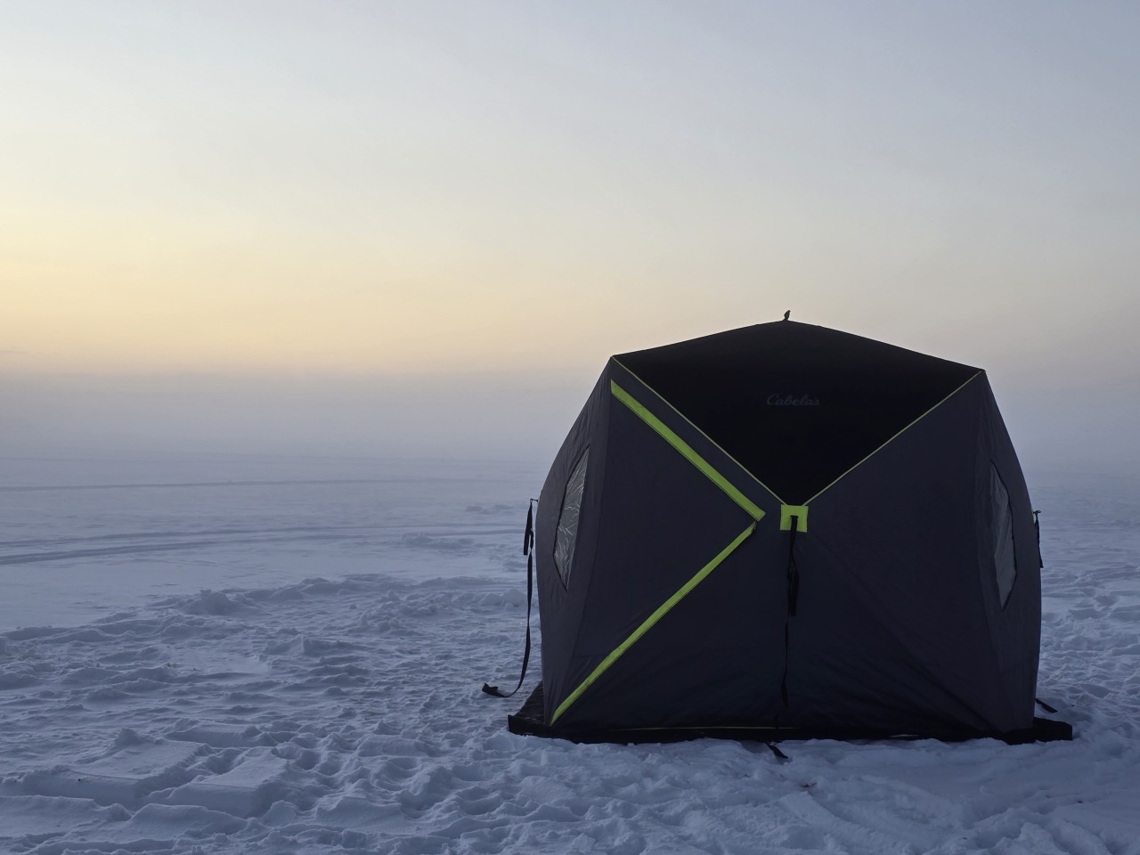 Foggy Ice Fishing Burnstick Lake Alberta  - Just before dark, a layer of fog rolled across the lake. Making me feel like I was far off in the distance on the lake. But really I was just a few meters from shore!

You can see how easily you could become disoriented if weather strikes up a challenge. Make sure you know exactly what direction you need to head when getting off the lake. It's also amazingly difficult to keep your bearings in the pitch black of night. Give yourself plenty of time to get off the ice safely if you aren't experienced. 